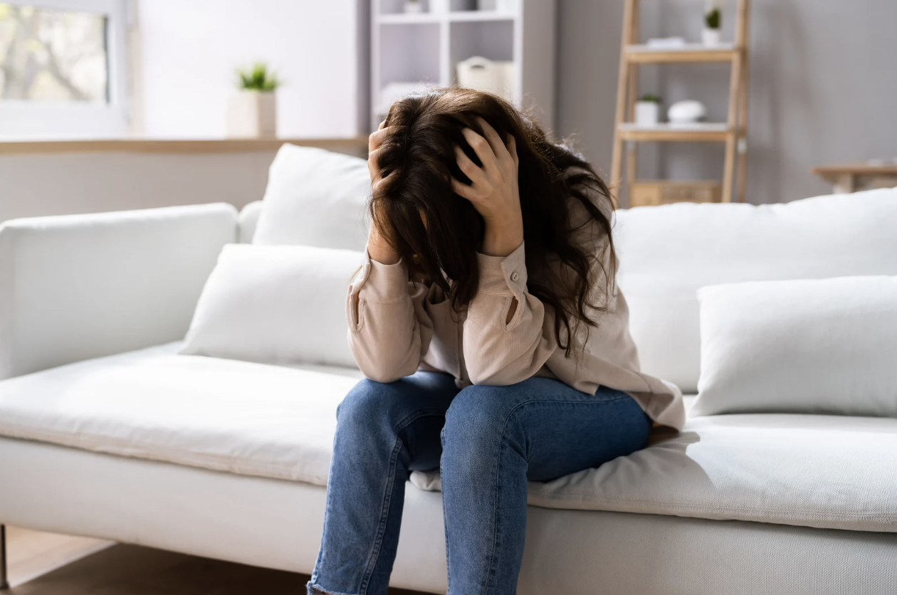 Woman experiencing emotional distress, potentially linked to gut-hormone imbalance.