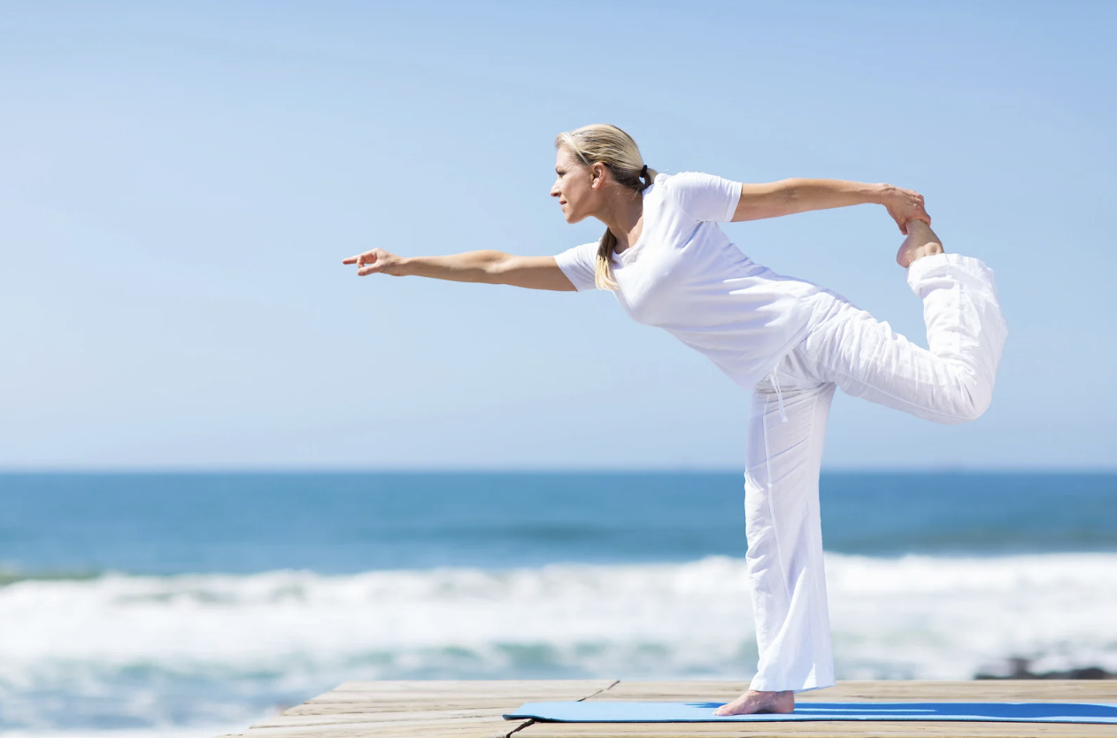 Woman practicing yoga to support hormonal balance and gut-brain health.