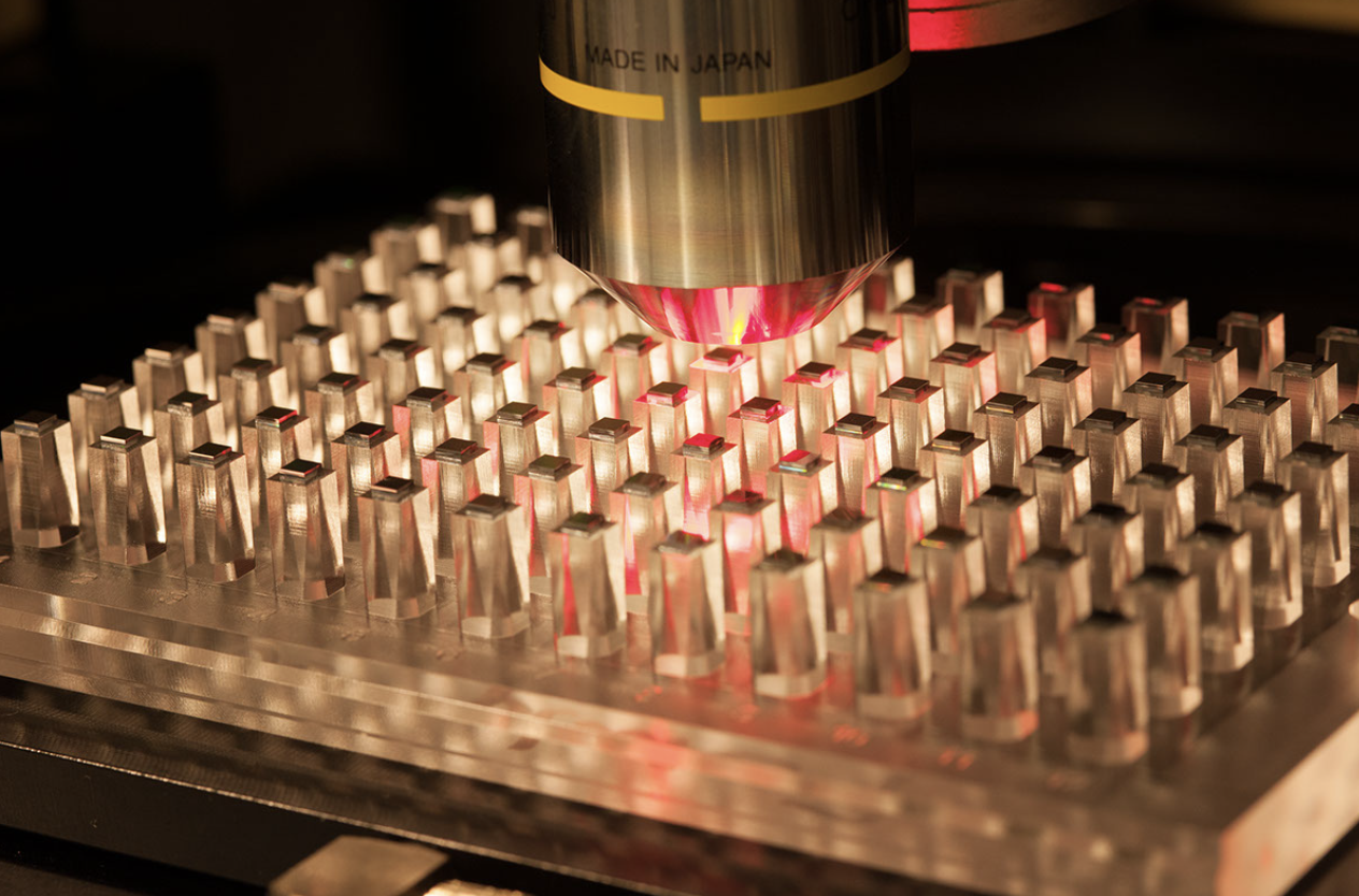 Close-up of a high-precision laser microscope analyzing a microarray, used for advanced scientific research and diagnostics.